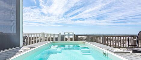 Gulf front pool. Perpendicular to the deck, it splits the deck into two.