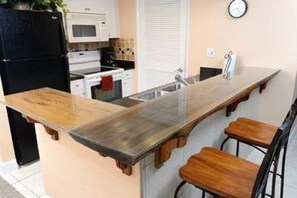 Full size kitchen with plenty of cookware.  Wood countertop