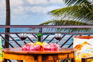 Ocean and beach view lanai! - Watch the whales breach from your lanai! There is a dining table with 4 chairs, a chaise lounge, and a side table.