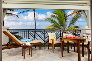 Ocean and beach view lanai! - Watch the whales breach from your lanai! There is a dining table with 4 chairs, a chaise lounge, and a side table.
