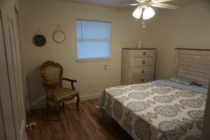 Bedroom with queen bed and plenty of closet space and drawers.