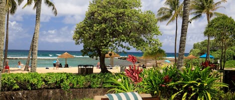 Ocean and beach view lanai! - Watch the whales breach from your lanai! There is a dining table with 4 chairs, a chaise lounge, and a side table.