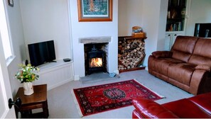 Living room with wood burner and two comfy recliner sofas