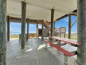 The patio is the perfect space to relax outdoors, complete with lounge chairs, a propane grill, and an outdoor shower with hot/cold water.