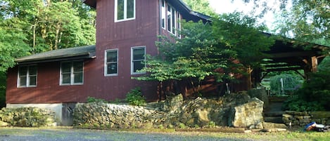 Secluded post-and-beam construction home surrounded by woods.