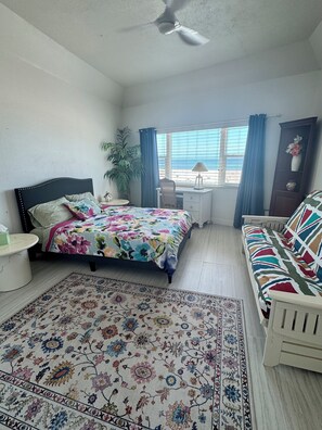 Second bedroom with a queen size bed , full size futon and desk with Ocean views