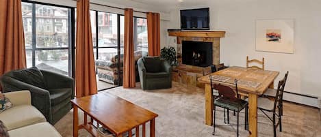 A cozy fireplace and flat screen w/DVD and movies  in your home away from home.