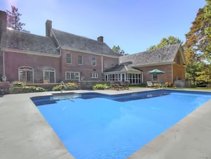 Pool is surrounded by beautiful perennial gardens and brick patios. Summer fun! 