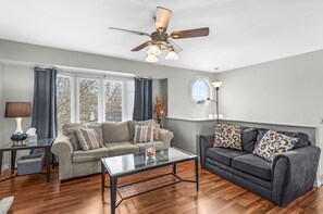 Elegant Living Room with queen sofa bed, smart TV, love seat, accent chair.