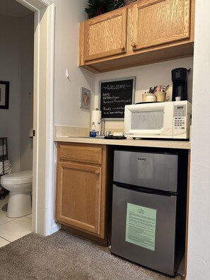 Convenience center with mini frig, freezer, coffee maker, microwave, sink,dishes