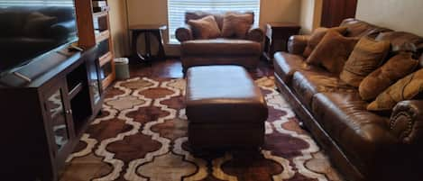 Living Room with 55 in TCL Roku TV; Big comfortable leather sofa and loveseat