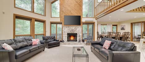 Huge, open concept living room. Plenty of seating, 72 inch TV, wood fireplace
