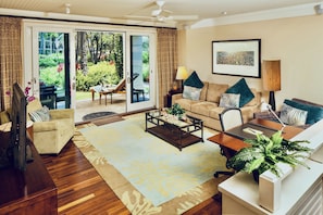 Living room - with pull-out gel memory foam sofa bed and 55" SMART TV and ceiling fan.