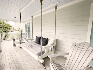 BALCONY WITH HANGING BED AND ADIRONDACK CHAIR SEATING