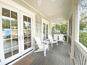 INVITING FRONT PORCH WITH ADIRONDACK SEATING