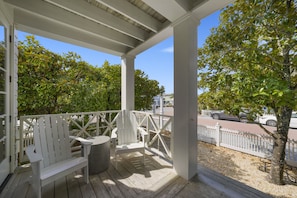 GENEROUS, PRIVATE FRONT PORCH WITH SEATING OVERLOOKING YARD