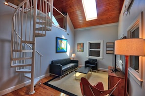 Living Room with Spiral Staircase to Loft