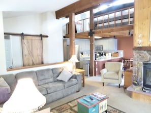 Living room looking back into kitchen and the sleeping loft is above. 