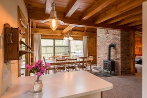 Dining room, with view out to lake Pauline. (Note: wood stove not for use)