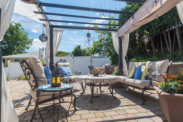 [Patio] Pergola with natural gas Zen fire table & river stream off to the left.