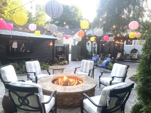 View from the cozy fire pit looking at the 70” smart tv or beautiful pergola