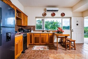 The kitchen is fully equipped to cook family meals and has AC to keep everyone cool!