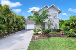 Front of home with well designed landscape welcomes you