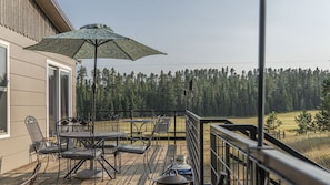 Deck, two tables with seating for 8, fire pit both gas and wood. 