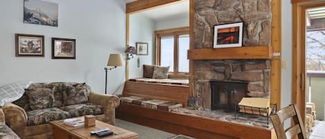 Living room with daybed and wood burning fire