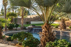 Lush landscape surrounds the perimeter of the pool