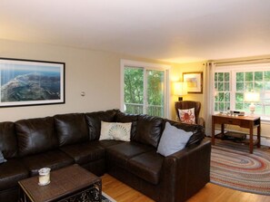 Large living room with access to back wrap around deck.