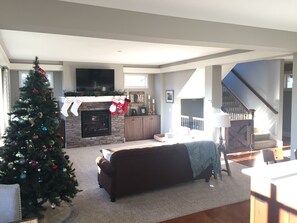 Spacious living room with gas fireplace and 55" TV. 