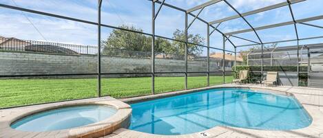 Enjoy the sunshine at your own screened-in pool