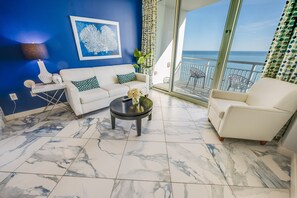 - Stylish living space with bold accents & ocean views, creating the perfect coastal retreat - Floor to ceiling windows fill the room with natural light, leading to a private balcony - Relax in comfort with modern décor & a refreshing seaside atmosphere