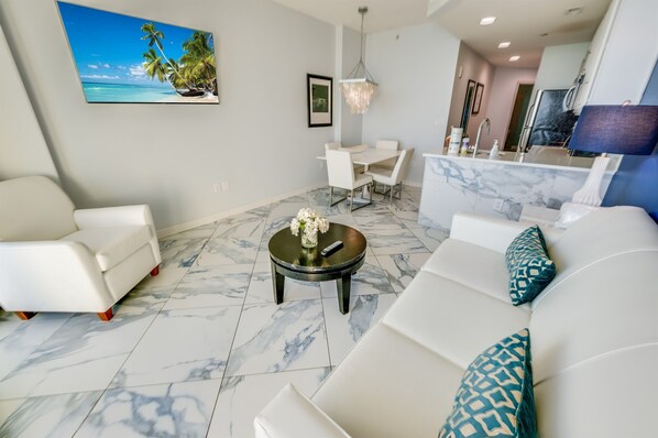- Bright, open concept living space designed for comfort, style & easy relaxation - Modern finishes, cozy seating & a seamless flow from the kitchen to the living area - Perfect for dining in, unwinding with a movie, or simply enjoying the beachside vibe