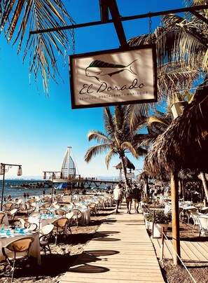 The beach chairs and boardwalk in front of the El Dorado Restaurant