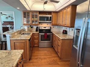 Full kitchen with dishware and cookware