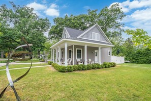 Front of property w/ two sided front porch w/ adirondack chairs and rocker.