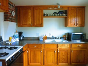 FULL KITCHEN HAS ACCESS TO THE PATIO WITH A BBQ GRILL