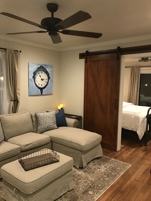 Rustic barn door, ceiling fan and original artwork. 