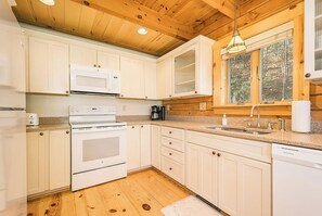 Kitchen - Refrigerator - divider  - Oven  and sink.