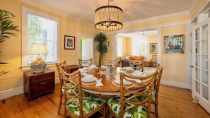 The formal dining room features a round dining table with seating for up to ten...