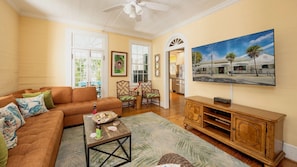 The living room has a large flat screen TV and comfortable furnishings...
