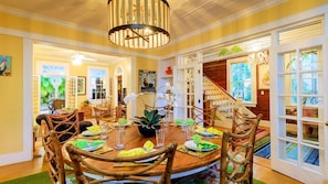 The formal dining room features a round dining table with seating for up to ten...