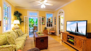 The living room has a large flat screen TV and comfortable furnishings...