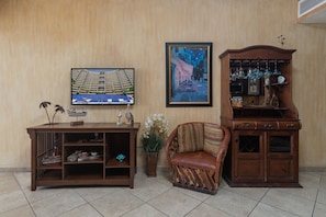 In the living room you will find this Wall mounted TV, entertainment center, and hutch.