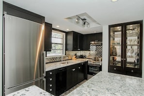 Incredible custom designed high end kitchen with space saving built in china cabinet.