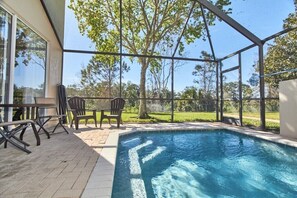 Private screened pool with serene backyard views.