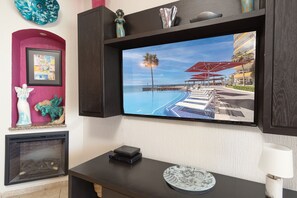 The large wall mounted TV in the living room.