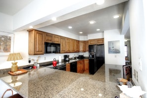 Kitchen - The kitchen has gorgeous granite counter-tops and wood cabinets.